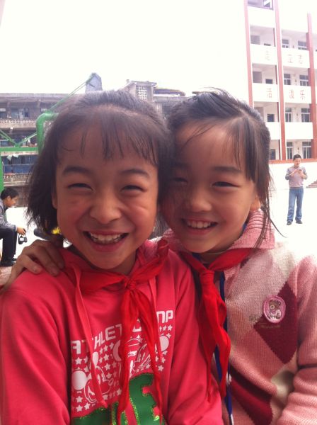 曾口小学四年级苟凤琳、刘湘湘收到助学金后开心地笑了
