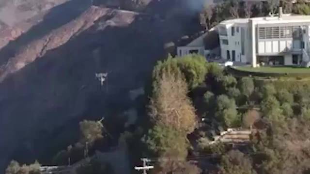 航拍：美国演员2600万美元豪宅山火后完好无损 邻居家被烧毁浓烟滚滚