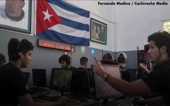 在国旗和领袖照片下玩《DOTA2》的古巴年轻人