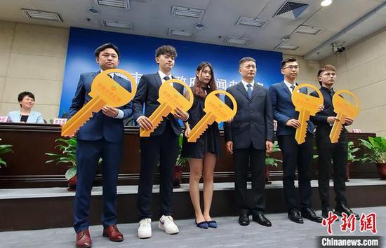 4月21日,广州南沙区规划建设的“青创人才公寓”正式投入运营。当天,南沙开发区(自贸区南沙片区)管委会副主任潘玉璋为首批入住的5名港澳青年颁发公寓钥匙。中新社记者 王坚 摄