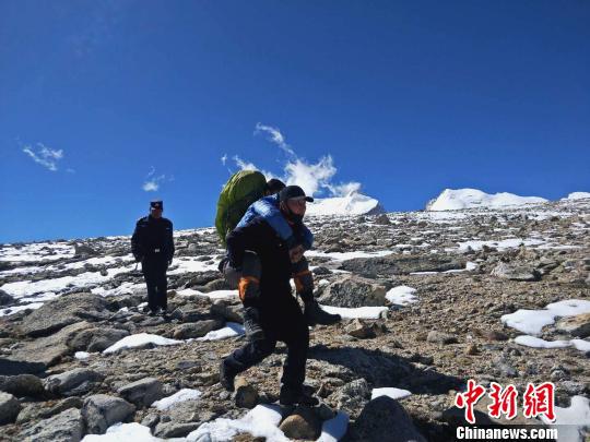 图为西藏吉隆民警将被困游客背下山。西藏日喀则市吉隆县公安局