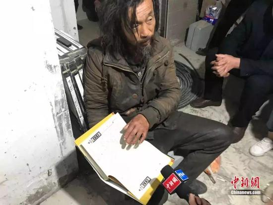 沈巍介绍《水浒传》的版本、包装。中新社 王子涛 摄