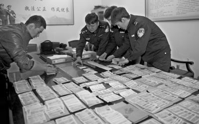 民警正在清点缴获的假火车票。京华时报通讯员 王旭红 摄