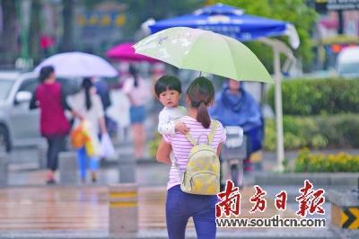 18日，受台风“莎莉嘉”影响，东莞降雨频密。图为鸿福路口，市民撑伞出行。