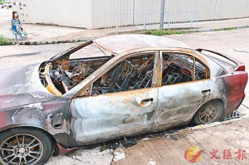 疑撞卷闸私家车遭人烧毁弃置路边。图片来源：香港文汇报