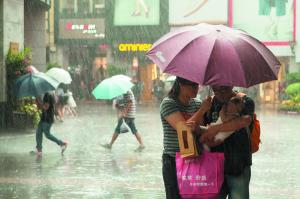  　　昨日傍晚广州突降暴雨。北京路步行街上，一对父母在雨中安抚怀中受雷声惊吓的婴儿。信息时报记者 朱元斌 实习生 陈迟 摄 