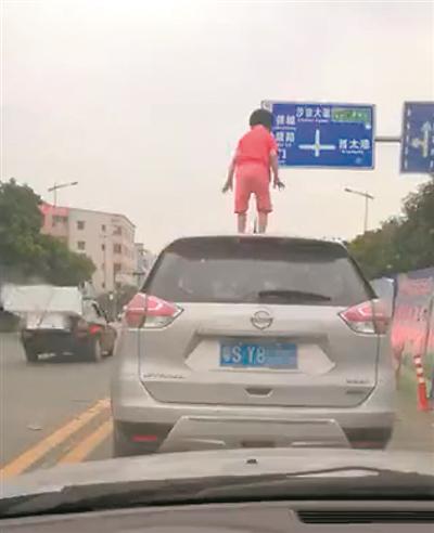 视频中,女孩从天窗爬上车顶。(视频截图)