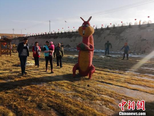 虽至寒冬,“稻草人”吸引游客们络绎不绝前来游玩。 崔琳 摄