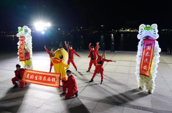身穿红色喜庆服装的舞蹈演员与“夜光”狮子共舞,在开幕仪式现场率先“闹春”