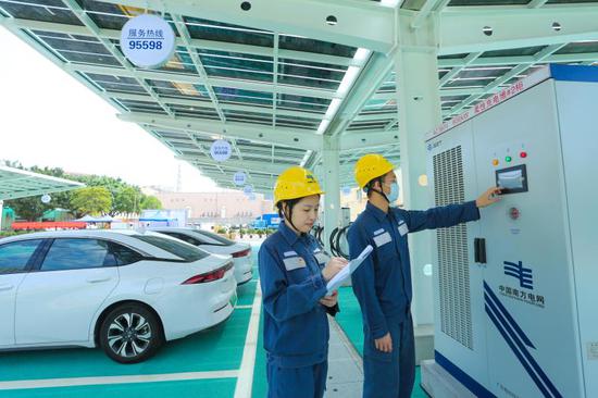 南方电网广东东莞供电局工作人员对电动汽车充电站进行检查。