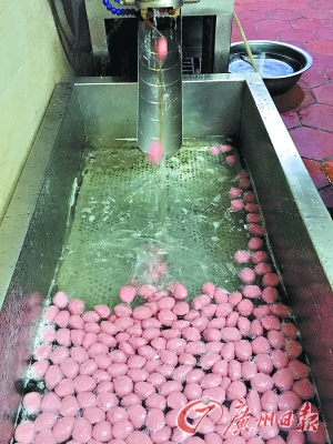 第四步:牛肉丸从机器口中“吐”出,掉到装有热水的煮丸机内