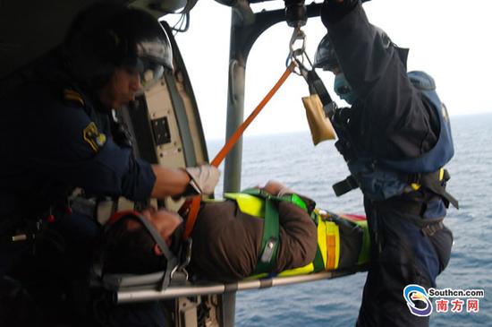 受伤渔民被救上直升机机舱。杨伟伟摄.