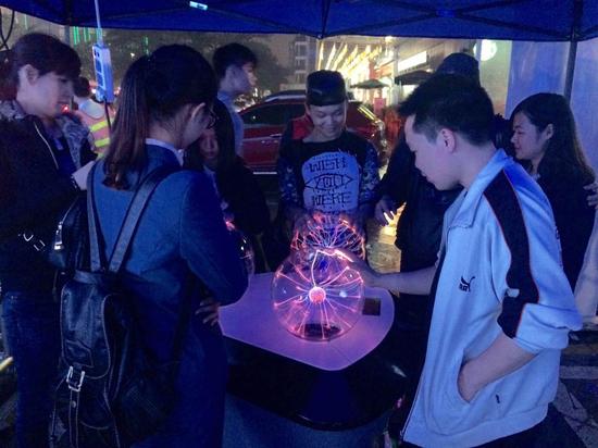 “辉光球”电力设备吸引了大小朋友前来感受体验。（摄影/文佳）