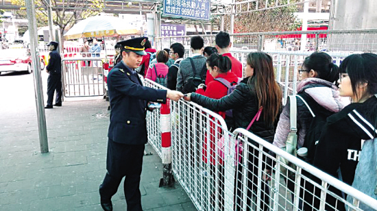 运政人员在火车站向乘客派发温馨提示卡。