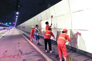 工作人员在清理隧道墙壁。