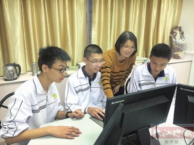 桂江一中信息学教师刘凤兰与学生讨论问题。