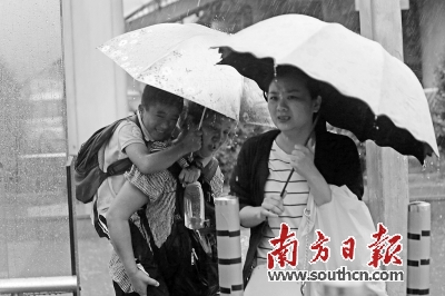 21日，我省多地出现了大雨到暴雨。图为在深圳街头，市民在冒雨前行。南方日报记者 朱洪波  摄