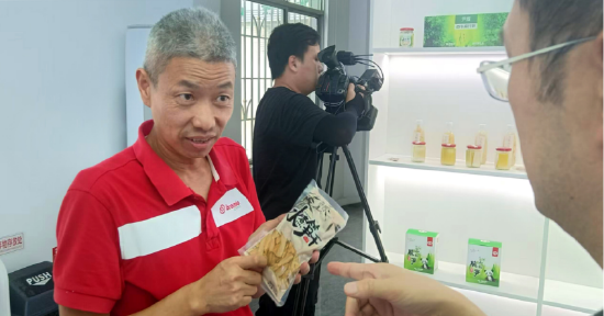 图为西牛华笋麻竹笋加工厂负责人胡兵安向媒体介绍公司产品