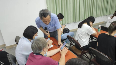 陈卓铭现场指导群众使用小程序