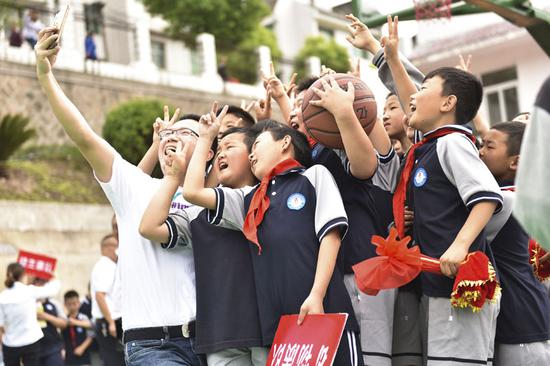 志愿者与航天希望小学学生在趣味运动会后合影。