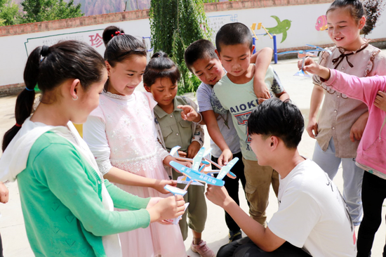 浙江大学志愿者和学生一起制作航模