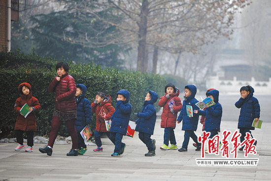 上午，北京市海淀外国语实验学校，留在学校的学生在老师的带领下前往充气膜体育馆躲避雾霾。本报记者 李隽辉/摄