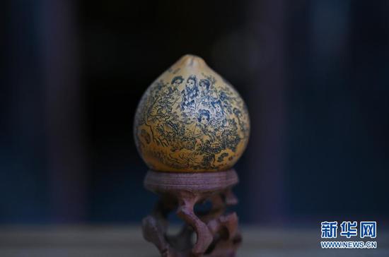 这是3月31日在兰州刻葫芦传习所拍摄的甘肃省工艺美术大师阮琳雕刻的葫芦作品《金陵十二钗》。 新华社记者 刘洁 摄