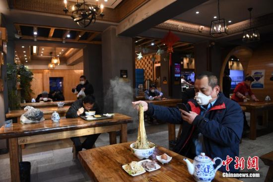 2月19日,甘肃省兰州市的市民在一家牛肉面馆里就餐。