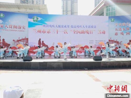 图为兰州市残障人士坐在轮椅上表演扇子舞。 闫姣 摄