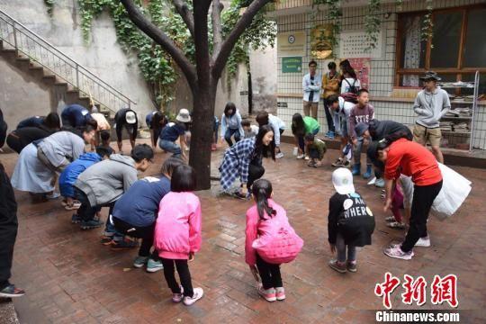 图为志愿者与孩子们一起学习趣味英文歌曲。 戈正尧 摄