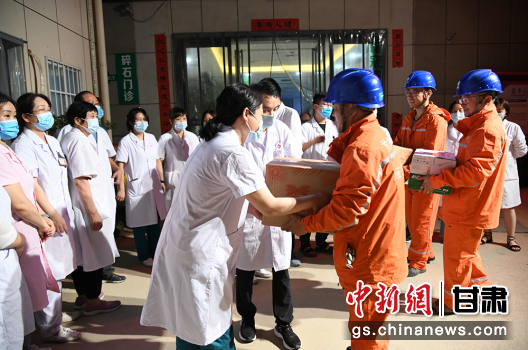 图为国网定西供电公司员工为郑州医护人员送上慰问品。