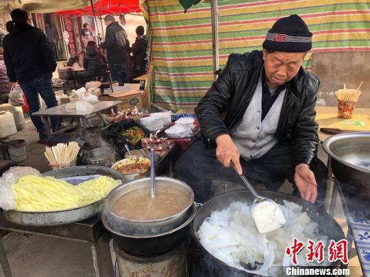春节期间,甘肃甘谷县街头特色小吃凉粉飘香添年味。 徐雪 摄
