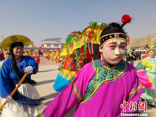 图为魏建孔时而咧嘴斜眼,时而屈膝行礼表演,引周围观众连连叫好。 闫姣 摄
