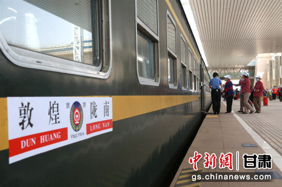 5月22日,旅客在甘肃敦煌火车站登上敦煌至陇南Y703/2次“环西部火车游”专列。