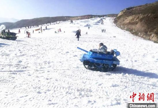 孩童在黄土高原下的滑雪场中游玩