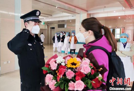 图为崆峒公安分局警犬训导员袁宏伟与支援武汉的妻子邢燕告别。