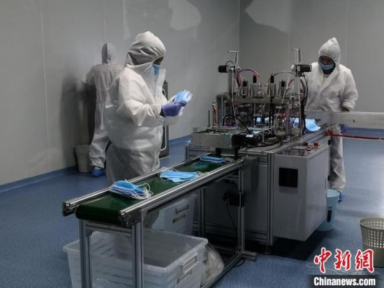 图为入驻西部药谷的医疗器械公司工人加紧生产口罩。