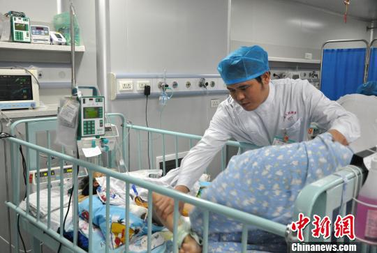 图为蒋小辉在护理病房里的危重症患儿 黄艳梅 摄
