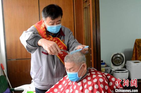 3月5日,柳州机车车辆有限公司志愿者王献忠为独居老人提供免费理发服务。 孙赟飞 摄