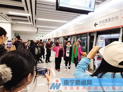 特意赶来“尝鲜”的市民站在地铁2号线列车旁快乐留影