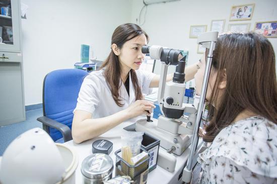 郑主任为近视患者做眼部检查