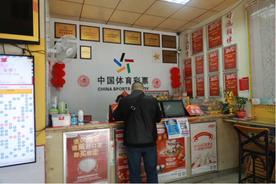 图为 购彩者正在购彩