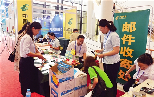 邮政工作人员现场办理邮件收寄业务,市民购物后可以直接打包邮寄