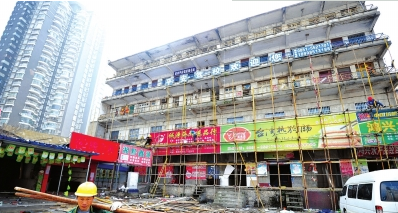 工人正在安装支架,拆除贵阳市花冠路北段道路已征收房屋。