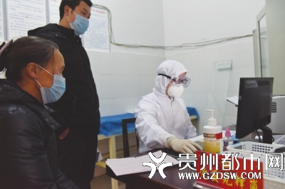 松桃苗族自治县人民医院党员吴崎嵩正在为发热患者诊疗。