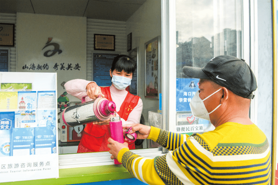 △汽车西站学雷锋志愿服务站，志愿者为有需求的旅客添上热水。海口日报记者陈长宇 摄