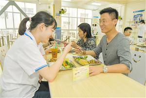 3月21日，海口实验中学的老师们陪同学生在食堂进餐。 海口日报记者 李天平 摄