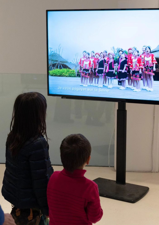 你好!中国 阳光海南”国际影像展暨海南旅文推介活动两名法国儿童在欣赏歌曲MV《把五指山唱给法兰西》,这首童声合唱曲目系海南省五指山市为中法文化旅游年而作。