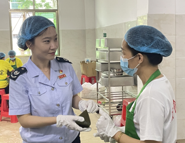 （图为税务干部向文昌会文凤会糯米花厂工人了解粽子制作流程，并为企业送去惠企政策“大礼包”。董乐乐摄）