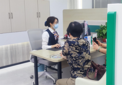 图：工作人员为老人提供便捷服务